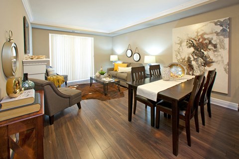 a living room and dining room with a table and chairs