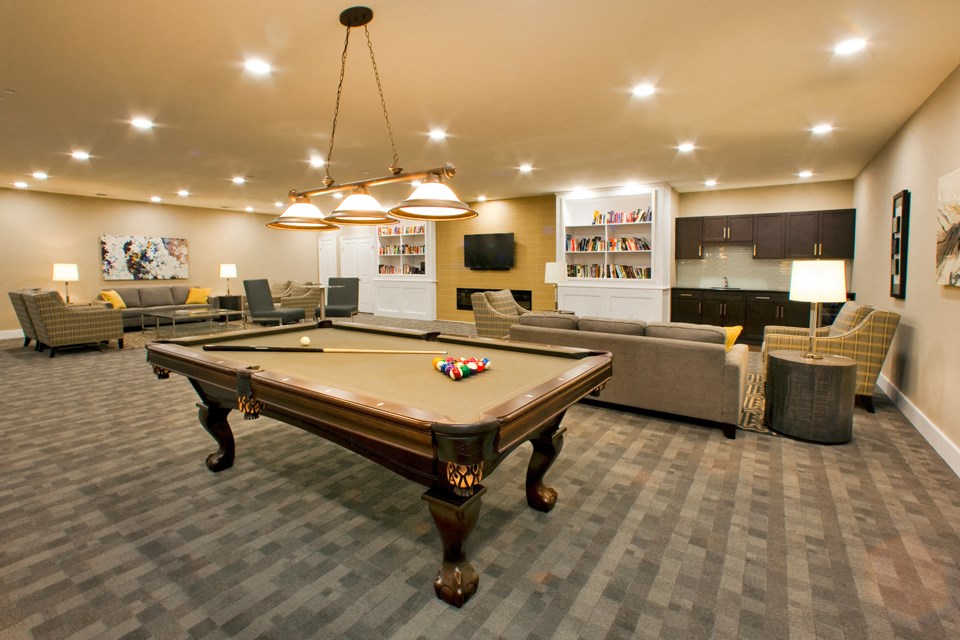 Juliana Place Apartments social room featuring lounge seating and pool table in Woodstock, ON