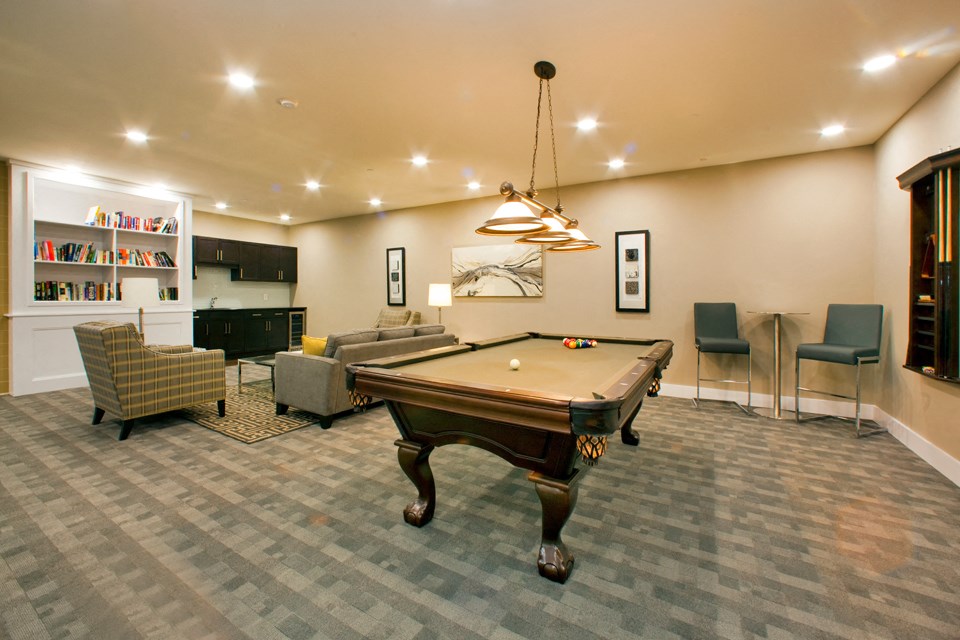 Juliana Place Apartments social room featuring lounge seating and pool table in Woodstock, ON