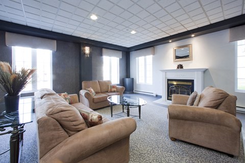 Heritage Lofts apartments lobby featuring lounge seating and fireplace in Gatineau, QC