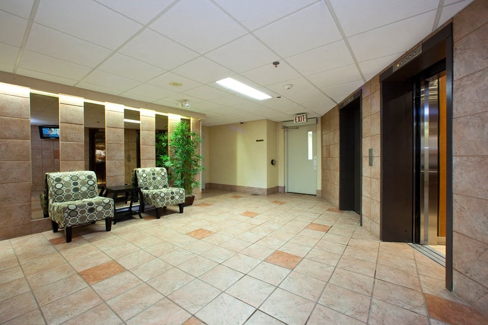 Pembridge Square lobby with seating and elevators in Kingston, ON