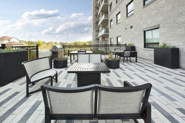 Watson Park Apartments roof top terrace featuring planters and lounge seating in Guelph, ON