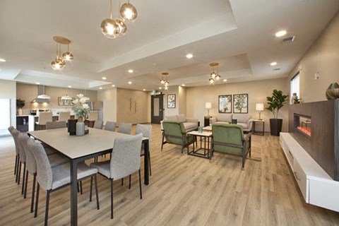 Watson Park Apartments social room featuring fireplace, lounge seating and large dining area in Guelph, ON
