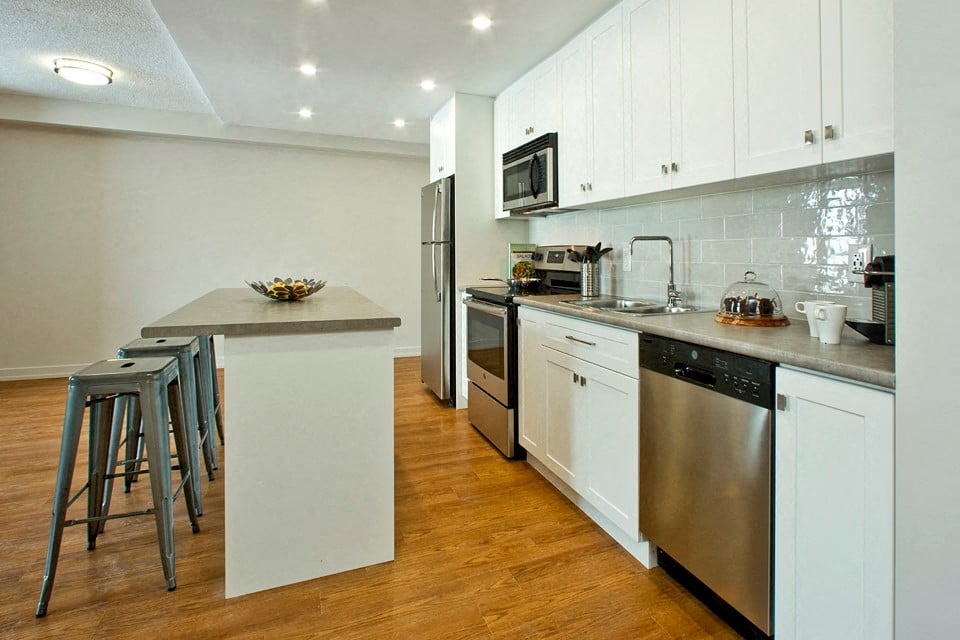 Squire Court kitchen with stainless steel appliances and island in St. Catharines, ON
