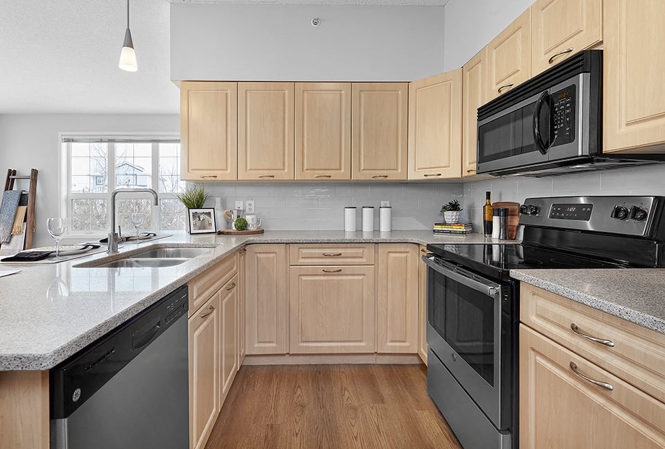 Wellington Court modern kitchen with stainless steel appliances in Edmonton, AB