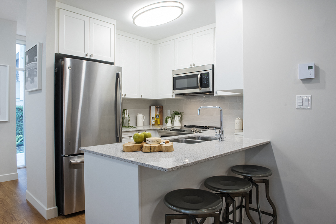 Wesley Place in Vancouver, BC Two bedroom townhouse kitchen featuring stainless steel appliances