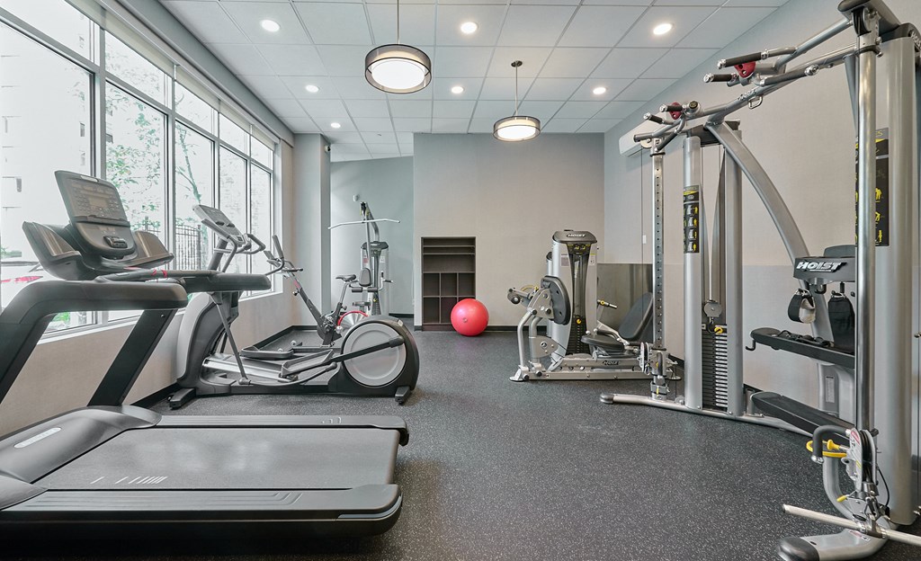 a gym with treadmills and other exercise equipment at Wesley Place Apartments in Vancouver British Columbia