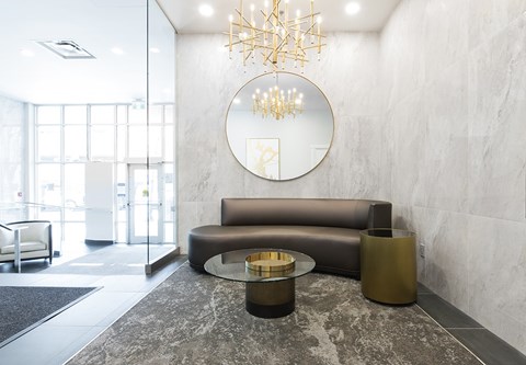 a living room with a round mirror and a couch