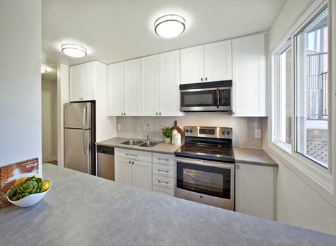 a kitchen with a stove and a sink and a microwave