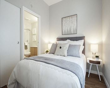 a bedroom with a bed and a door to a bathroom