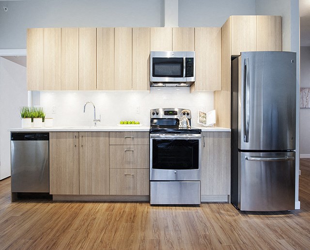 Yello On Yates modern kicthen with quartz countertops and stainless steel appliances in Victoria, BC