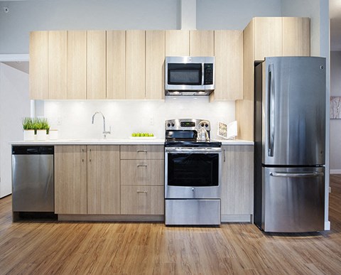 a kitchen with stainless steel appliances and wooden cabinets