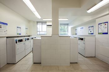 a row of washing machines in a laundry room