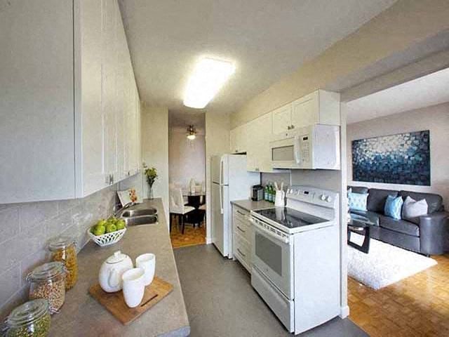 Highpoint Barrie Sleek kitchen with stove, microwave, fridge and counter top in Barrie, ON