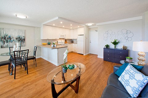 a living room and kitchen with a glass table