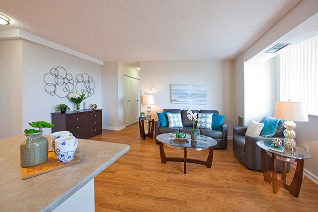 Live comfortably in classic apartment units Edgehill Apartments in Barrie, ON modern living room with two couches and a round glass coffee table