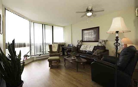 a living room with leather furniture and large windows