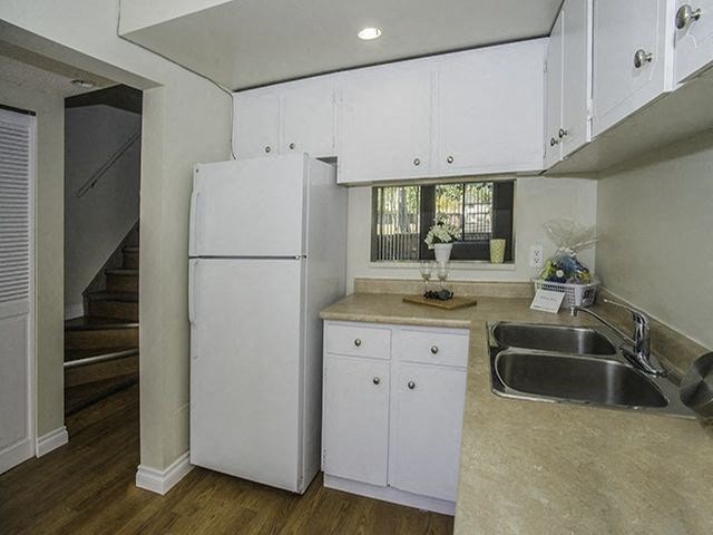Willowbrook Estates in Brooks, AB kitchen with fridge and small window