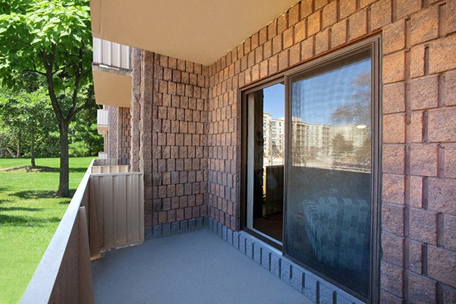 Mountain View Ground level balcony with glass doors and a view of lush green trees and grass in Collingwood, ON