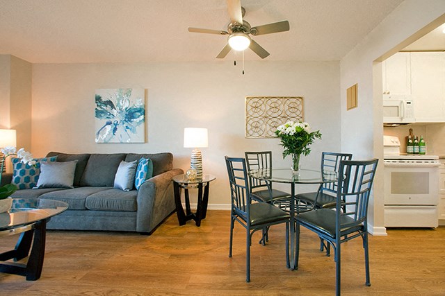 Mountain View Living room that connects to the dining room, a fan is on the ceiling and there is a table with four chairs around it near the entrance to the kitchen in Collingwood, ON