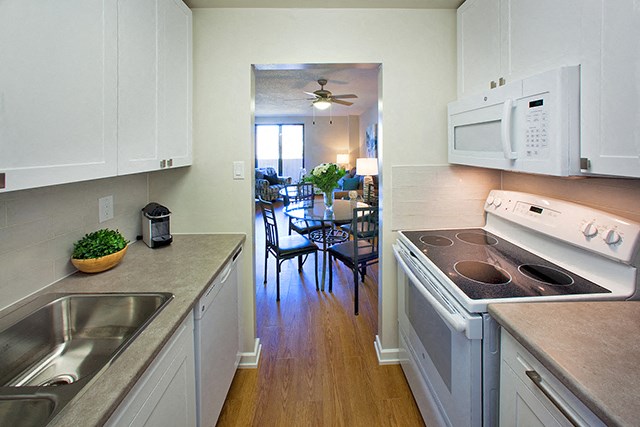 Mountain View View from kitchen to dining room and living room. A stove, microwave, cupboards and sink are visible in Collingwood, ON