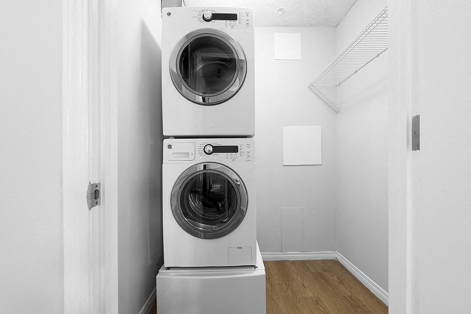 A washing machine is placed in a room.