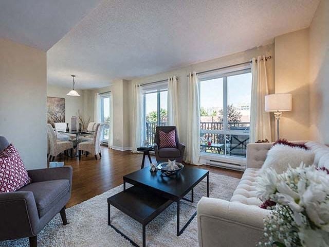 Excelsior Apartments open concept living room with access to balcony in Montreal, QC