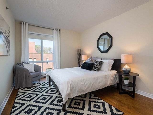 Excelsior Apartments master bedroom with hardwood flooring in Montreal, QC