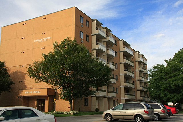 Modern exterior or Marlan Tower with parking lot on the side of the building in Owen Sound, ON