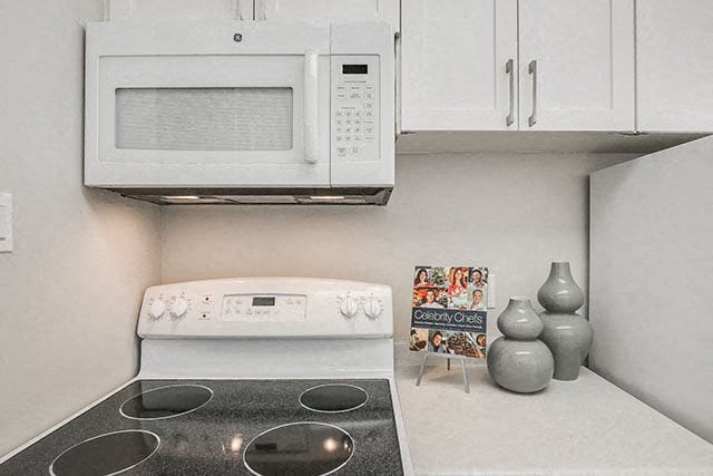 Victoria Place kitchen with over-the-range microwave in Saskatoon, SK