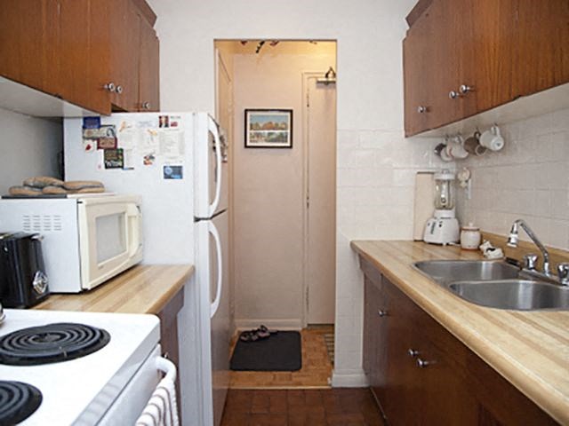 Glen Park Apartments in Toronto, ON kitchen with fridge, stove and microwave appliances