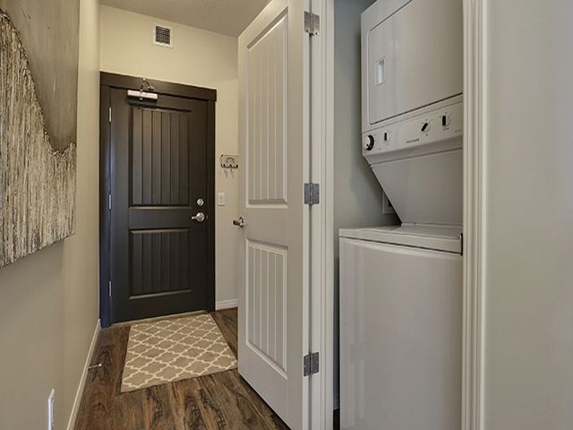 Airdrie Place in Airdrie, AB Washer/dryer in efficient closet in main hallway