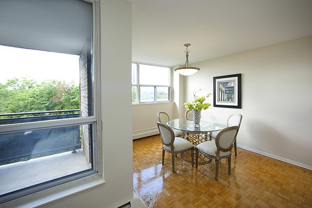 Brookbanks Apartments cozy dining area with balcony access in Toronto, ON