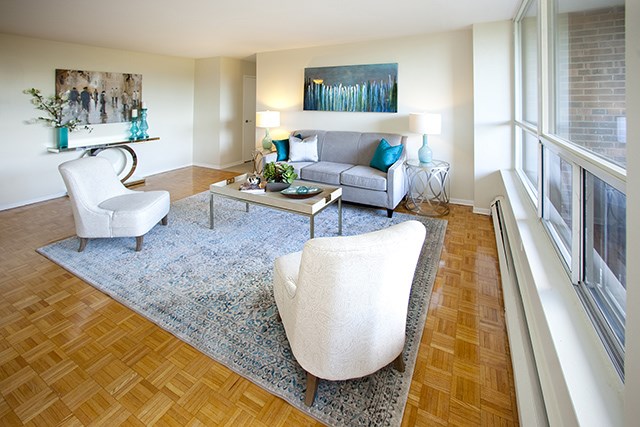 Brookbanks Apartments living room with hardwood flooring and large windows in Toronto, ON
