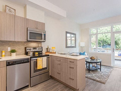 A kitchen with a stove top oven and a microwave above it.