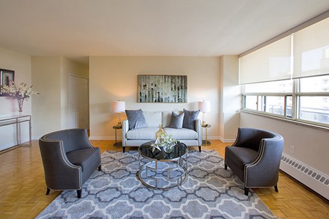 a living room with a couch and two chairs