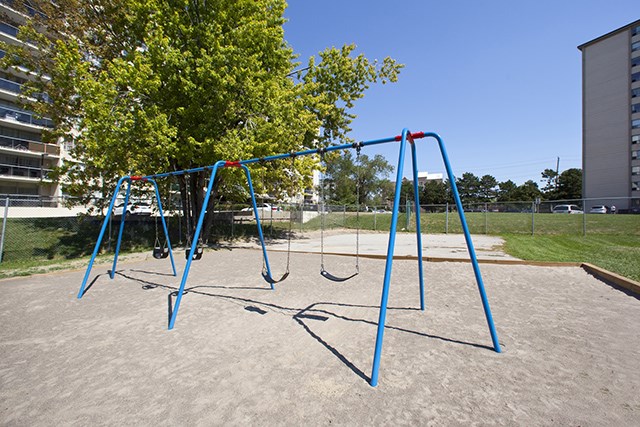 Rockford Apartments playground with swings in Toronto, ON