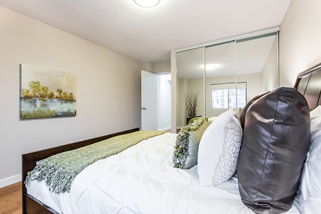 Secord House in Edmonton, AB bedroom with mirror sliding doors for closet