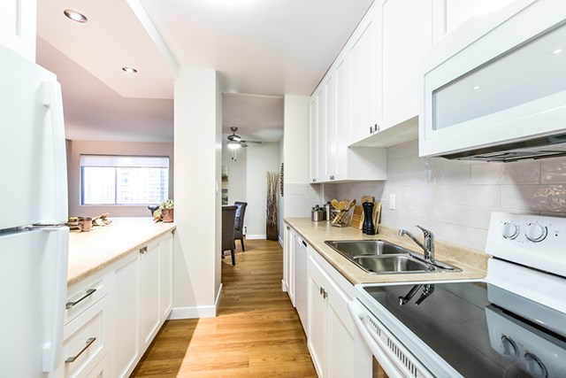 Secord House in Edmonton, AB kitchen with fridge, stove, microwave and dishwasher