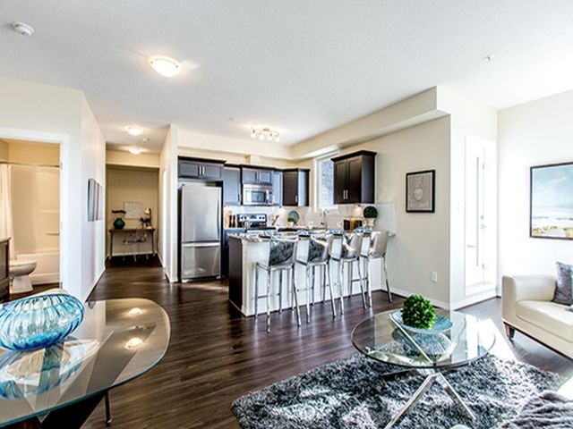 Giroux Estates in St. Albert, AB kitchen with breakfast bar granite counter tops