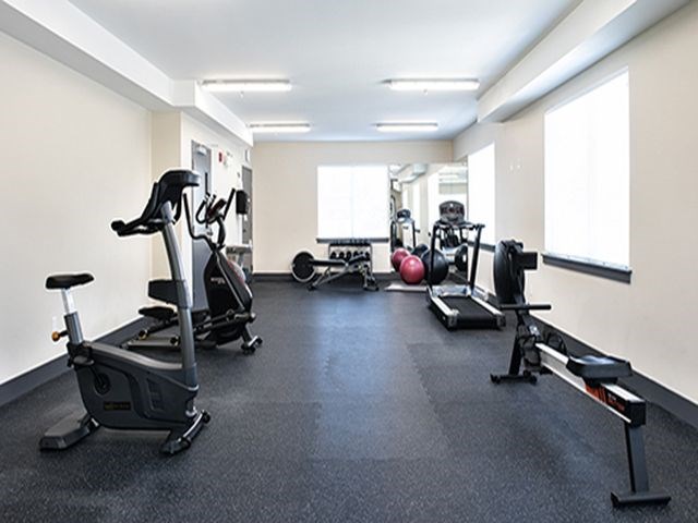 a gym with various exercise equipment on the floor