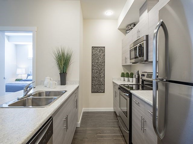 a kitchen with stainless steel appliances and a sink