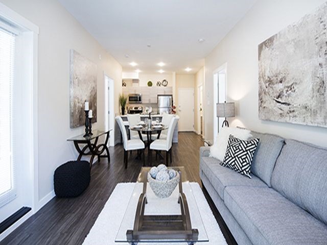 Summerhill Place in Nanaimo, BC Living room with view into kitchen and dining area