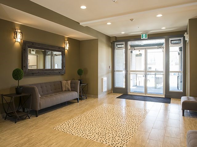a lobby with a couch and a mirror