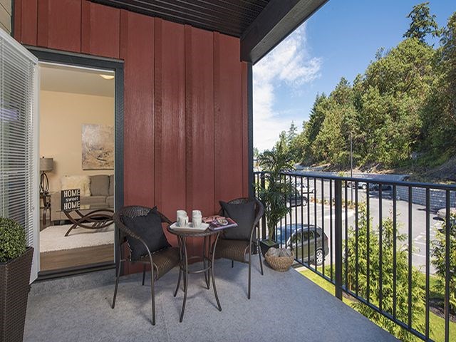 a patio with a table and chairs on a balcony