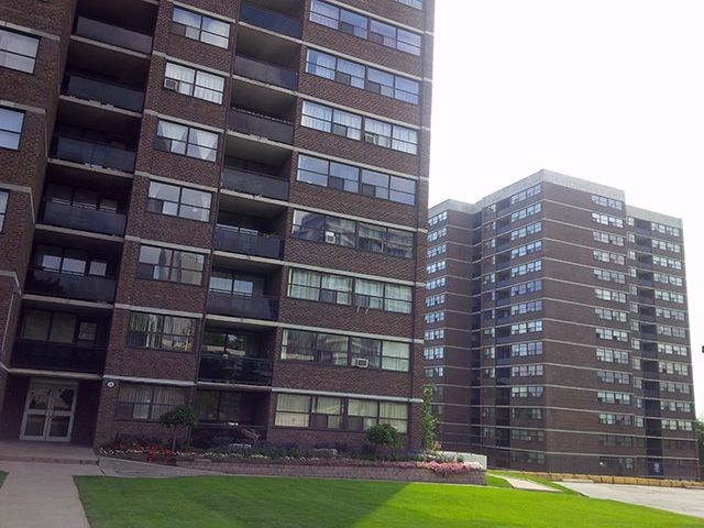 two apartment buildings are next to each other on a street