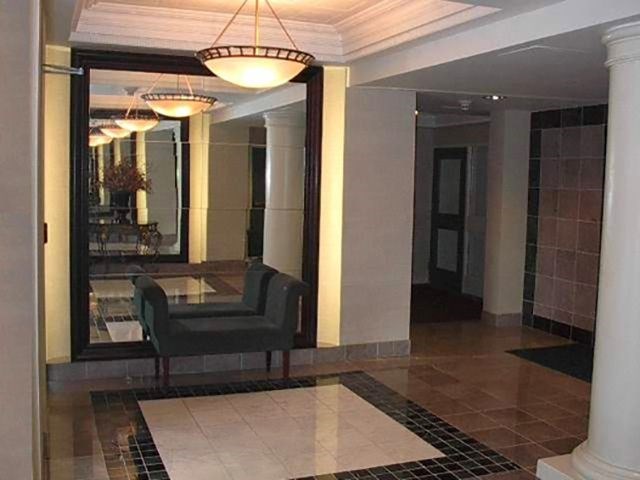 a lobby with a chair and a glass table