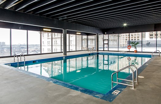 Enjoy lounging by the pool at upscale properties Efficiently designed swimming pools available at 99 Jasper in Edmonton, AB