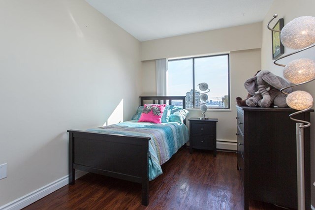 Shoreview in North Vancouver, BC Bedroom with unique round lamp and bed with teal covers