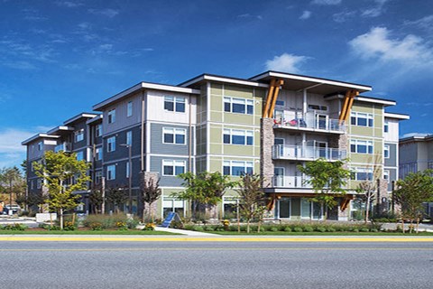 A large apartment building with a balcony on the second floor.